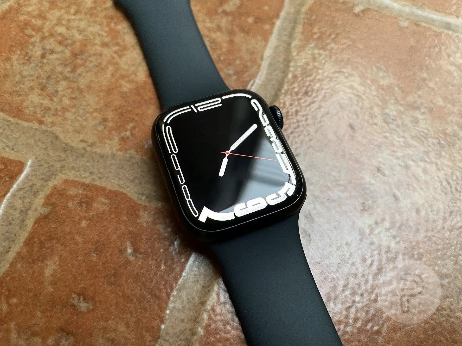 Apple Watch Series 7 placed on a tiled surface